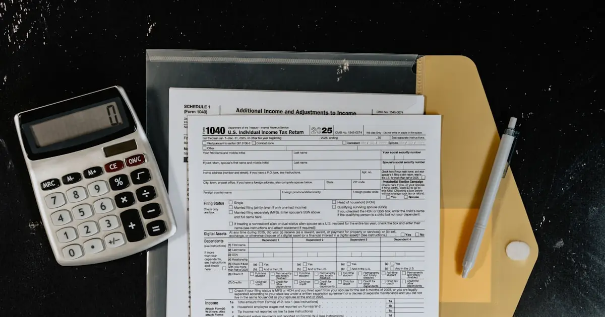 IRS Form 1040 tax return beside a calculator, representing the after-tax income difference between covered-call ETFs